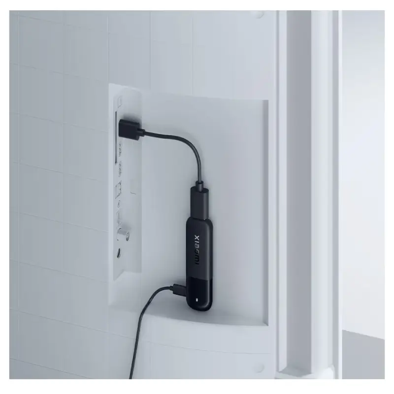 Xiaomi TV Stick HD 2nd Gen plugged into a television HDMI port